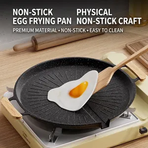 Non-stick Korean griddle pan with stone coating and wooden handles on portable stove