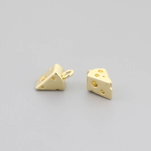 Macro view of two 18K gold plated cheese slice pendants with smooth metallic finish