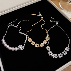 Close-up of elegant zircon flower bracelets with pink pearls and adjustable clasp