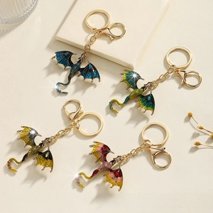 Detail of colorful dragon keychains featuring enamel finish and sparkling rhinestones