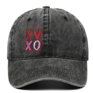 Washed black denim baseball cap with XO heart embroidery in a vintage distressed style