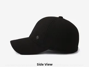 Side view showing thick black textured twill fabric and metal logo on the winter baseball cap