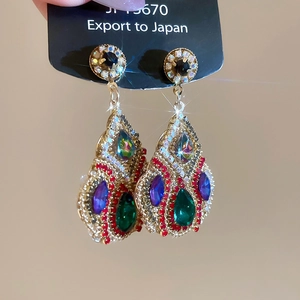 Macro shot of luxury palace-style earrings featuring colorful zircon waterdrop pendants