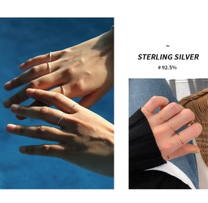 Detail of minimalist 925 sterling silver thin rings in silver and gold for stacking