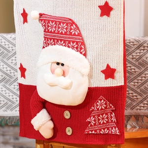 Christmas chair cover featuring 3D Santa Claus figure and knit fabric on wooden chair