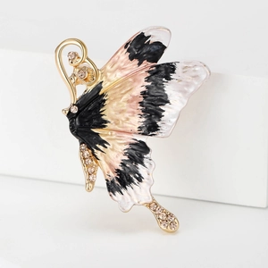 Detail of enamel butterfly brooch with pink and black wings and sparkling rhinestones
