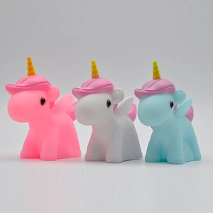 Three colorful unicorn night lights in pink, white, and blue with golden horns for bedroom