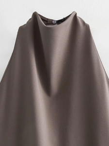 Detail of high neck halter top with back button closure in deep brown woven fabric
