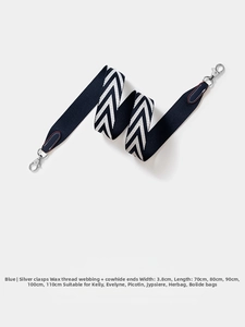 Detail of 3.8cm wide navy herringbone woven strap with leather ends and silver metal hooks