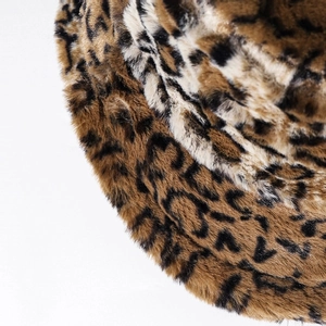 Close-up of thick faux fur texture and brown leopard pattern on a warm winter bucket hat