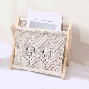 Handwoven macrame magazine rack with natural wood frame for Nordic home organization