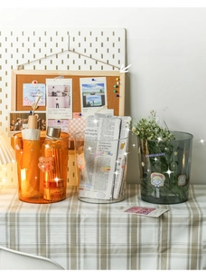 Three-piece desktop storage bins in orange, clear, and smoke grey with cute stickers