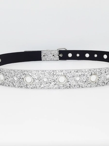 Macro detail of Y2K silver sequin belt with metallic eyelets and shiny square buckle