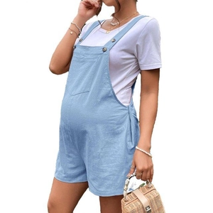 Detail of light blue maternity overalls with adjustable buckles and front chest pocket