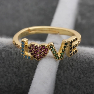 Detailed close-up of a LOVE letter ring with colorful cubic zirconia heart inlay
