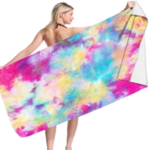 Macro detail of microfiber beach towel showing vibrant tie-dye patterns and soft texture