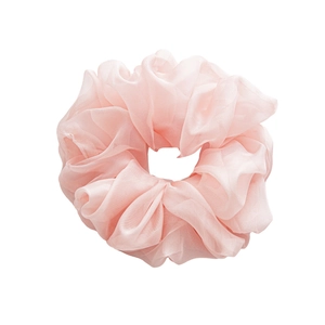 Pink large chiffon scrunchie with fluffy pleated fabric texture on white background