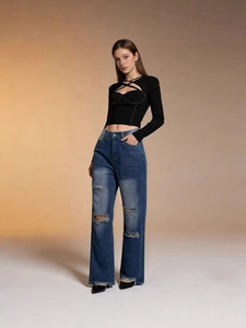 Black halter neck slim fit top paired with blue ripped straight leg frayed jeans