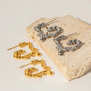 Lava textured heart-shaped hoop earrings in gold and silver finish on stone