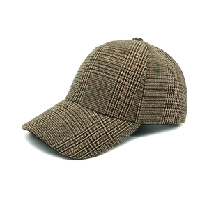 Detail view of vintage brown houndstooth baseball cap with textured woven fabric finish