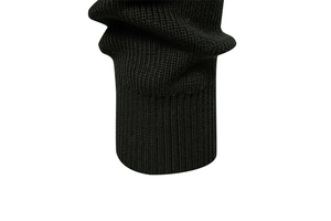 Detailed close-up of ribbed cuffs on a premium black business knit sweater for men
