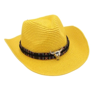 Detail of yellow woven cowboy hat with ethnic band and silver steer head ornament