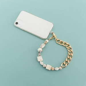 Bohemian acrylic and gold metal link phone strap with marble beads on mint background