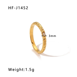 Macro view of gold plated titanium steel ring with lava texture and 3mm zircon inlay