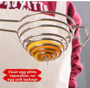 Detail of spiral stainless steel egg separator filtering egg white from yolk clearly
