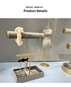 Detail display of gray velvet jewelry organizers including necklace bust and ring tray