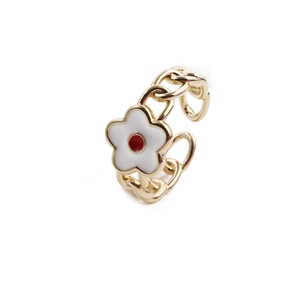 Detailed close-up of golden chain-style ring featuring white and red enamel flowers
