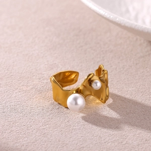 Macro shot of gold-plated irregular geometric ring featuring two white faux pearls