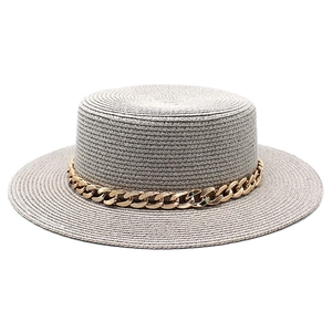 Detailed view of grey straw boater hat with stylish thick gold chain link band