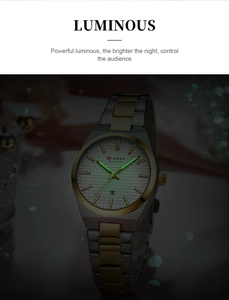 Close-up of Curren quartz watch dial showing green luminous hands and calendar in the dark