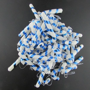 Scattered blue and white striped Christmas candy cane ornaments for holiday tree decor