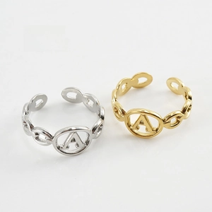 Detail of adjustable letter A rings with Cuban chain texture in gold and steel finish