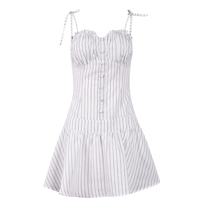 Detail of striped summer dress with bow straps, ruffled chest and button decoration
