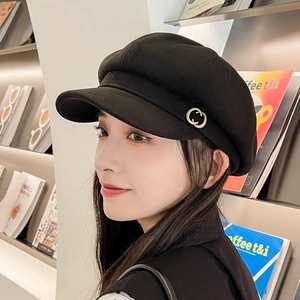 Classic black newsboy cap for women featuring vintage metal buckle on a soft fabric texture