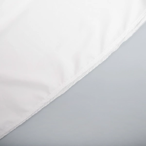 Detail shot of white chiffon dress fabric with smooth hem stitching and soft texture