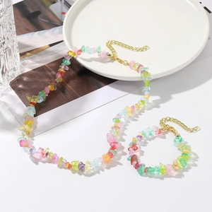 Detail of colorful gemstone chip necklace and bracelet set with golden alloy clasp
