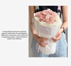 Close-up of pink roses wrapped in white pleated textured paper and waterproof film