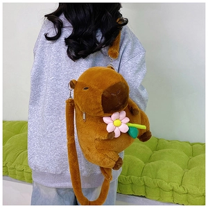Side view of a brown Capybara plush crossbody bag with cute flower accessories on a model