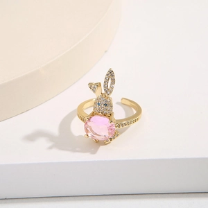 Gold plated copper rabbit open ring featuring a pink oval gemstone and zircon accents