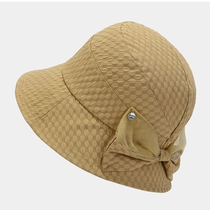 Women's beige sun bucket hat with honeycomb texture and large bow decoration