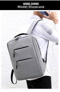 Grey business backpack detail showing the integrated USB charging port and sleek side profile