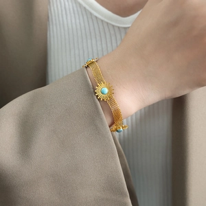 French style 18k gold turquoise flower bracelet featuring vintage mesh chain on female wrist