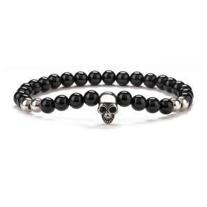 Mens 8mm black onyx beaded bracelet featuring a silver skull charm on a plain white background