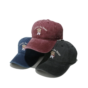 Three embroidered cartoon bear baseball caps in burgundy, navy blue and black