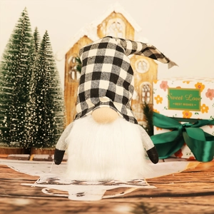 Christmas gnome doll with black and white plaid hat and warm light in cozy holiday setting