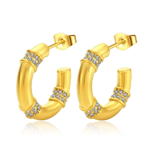 Elegant gold bamboo style hoop earrings with clear crystals on a white background